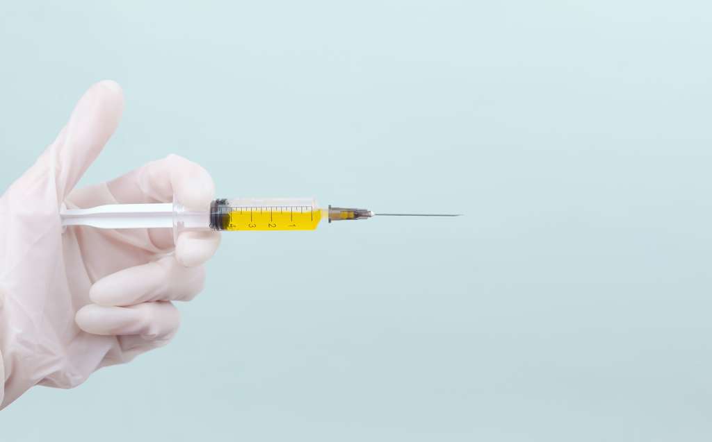 hand holding vaccine