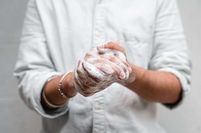 man washing hands with soap