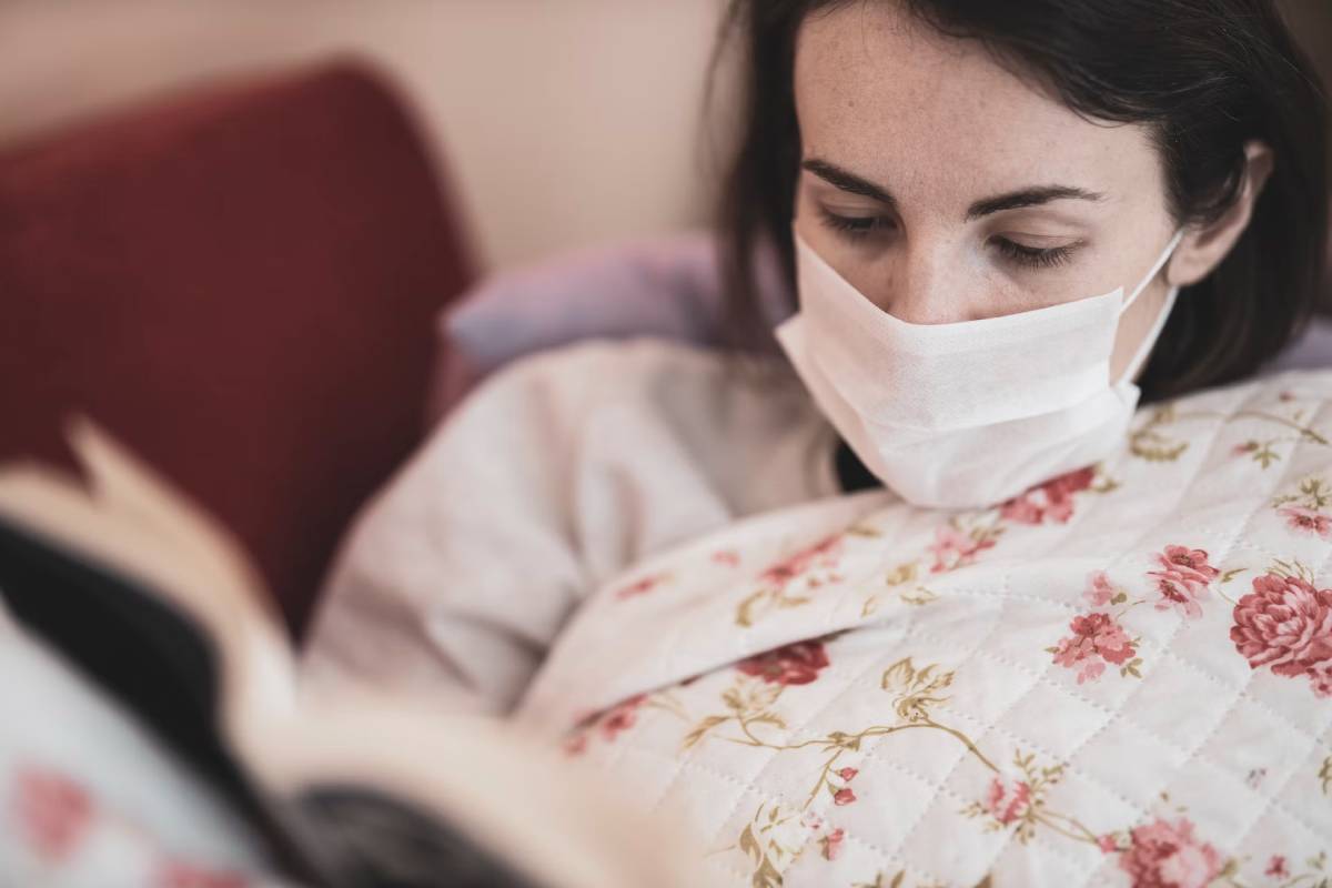 Woman wearing mask reading