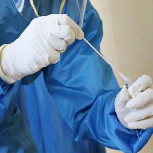 Doctor using swab for a COVID-19 test