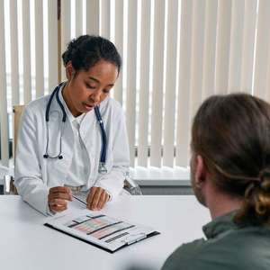 doctor conducting immigration medical exam with patient