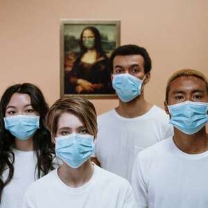 four people wearing masks