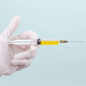 hand holding vaccine