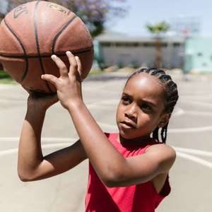 little kid playing basketball