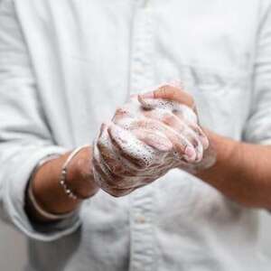 man washing hands with soap