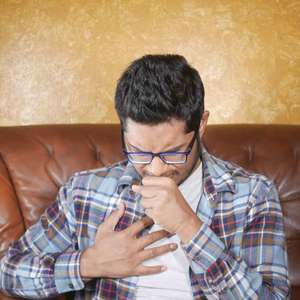 man with tuberculosis coughing