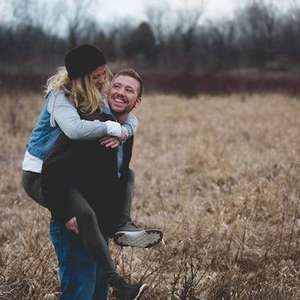 Man giving a woman a piggyback ride