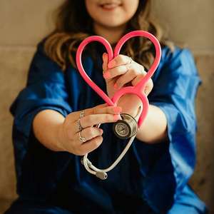 doctor holding stethoscope in the shape of a heart