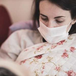Woman with the flu wearing a mask