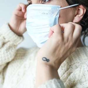 woman putting mask on
