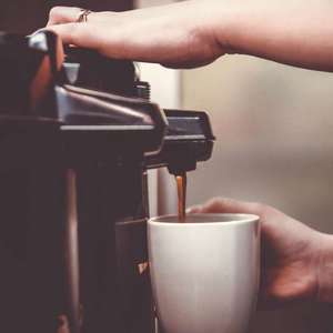 woman using coffee maker