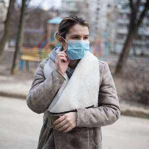 Woman wearing mask outside in winter