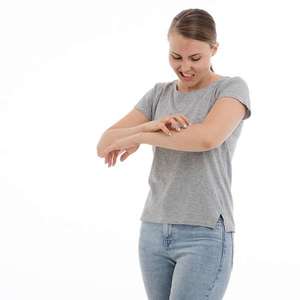 woman with shingles scratching skin