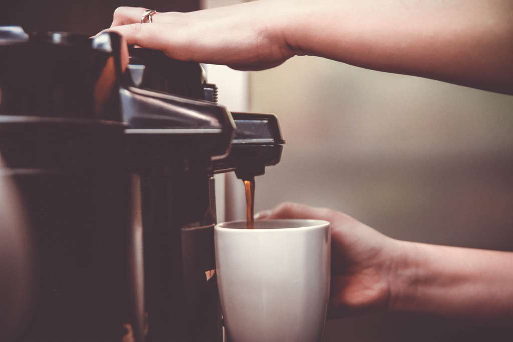 woman using coffee maker