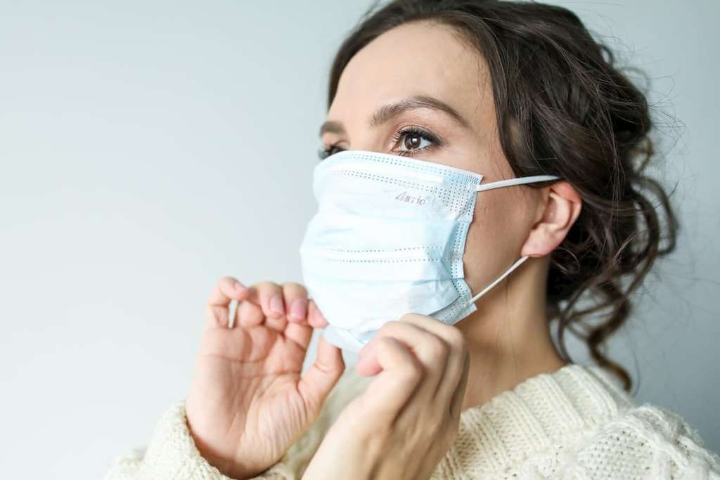 woman wearing white face mask