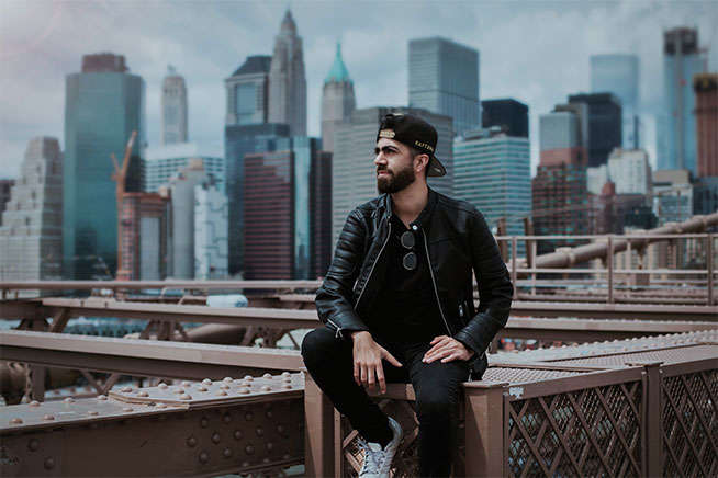 man sitting on top of building