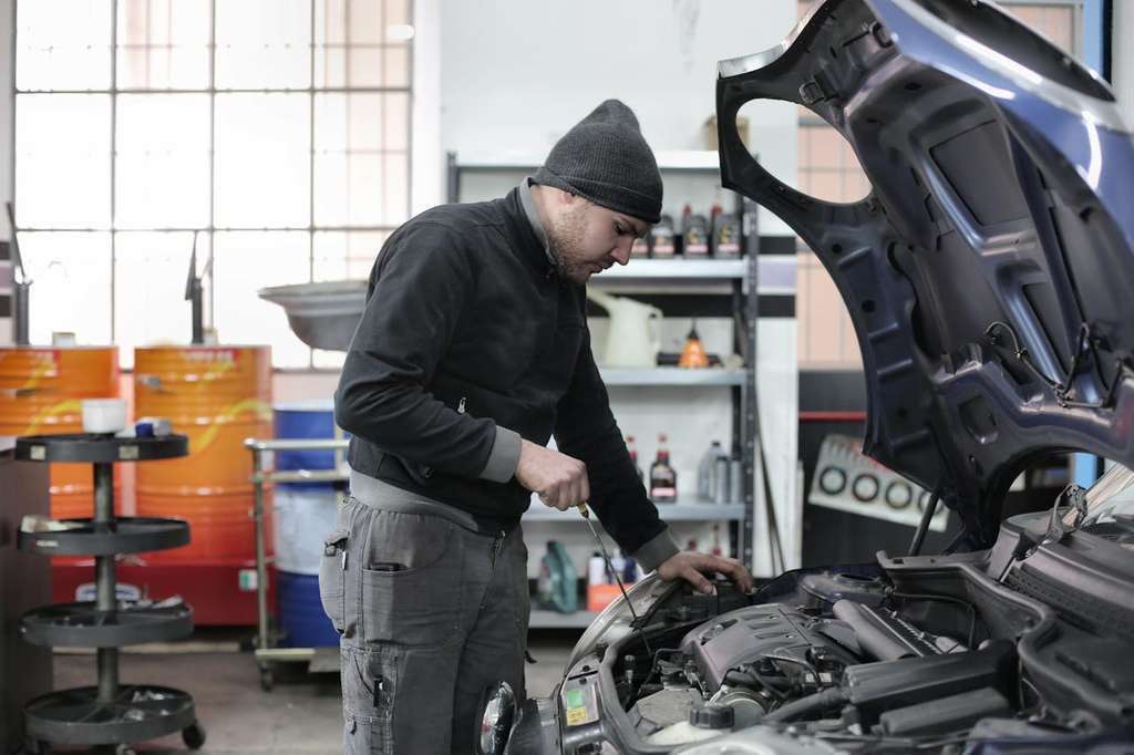 An automobile mechanic working on a car