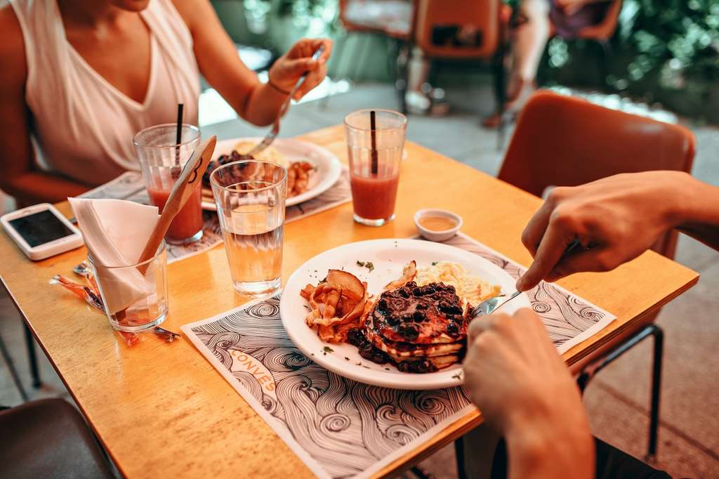 Two people eating breakfast at the table