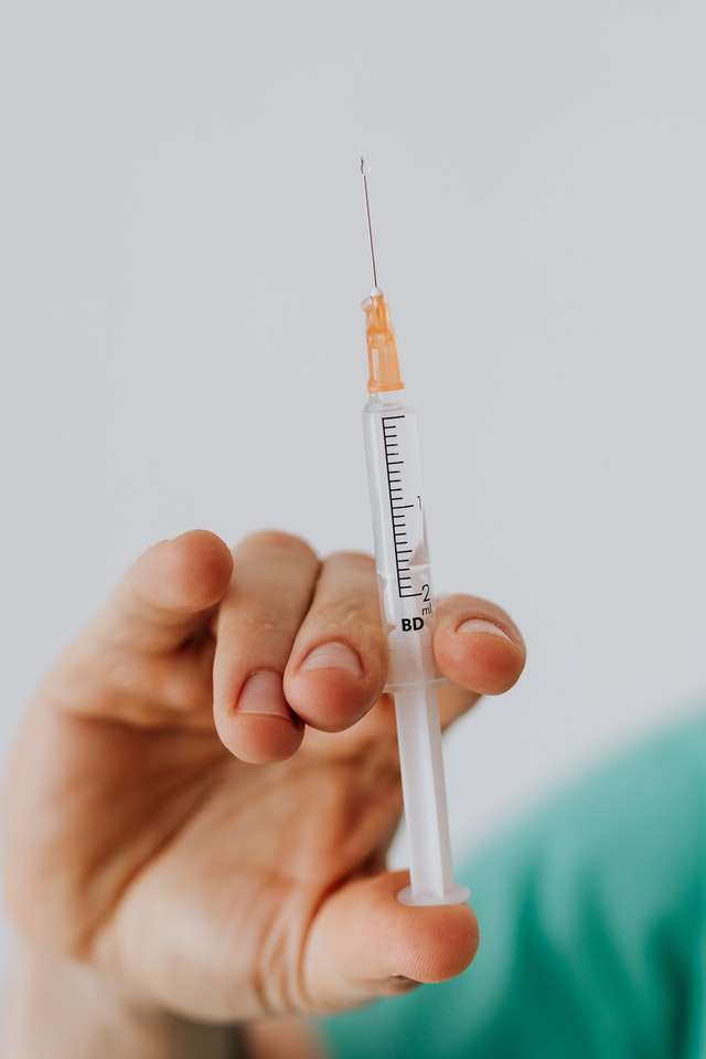 doctor holding vaccine