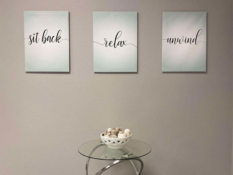 Office setting, 3 paintings on wall and small table
