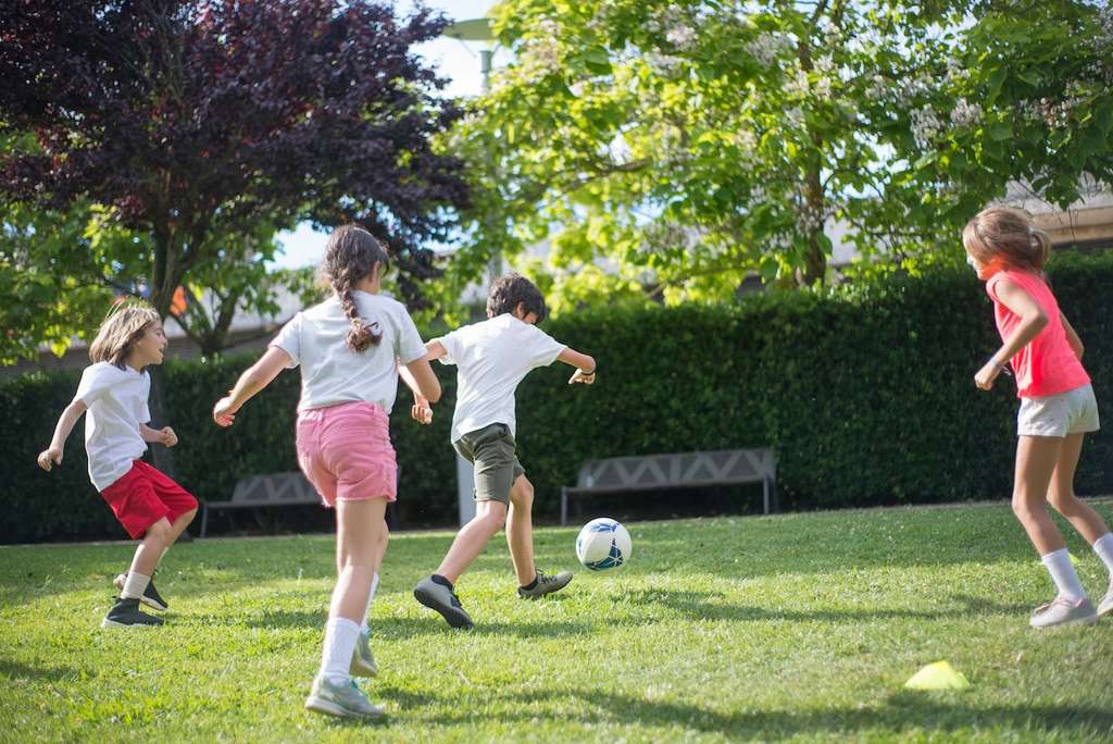 Kids playing soccer outside