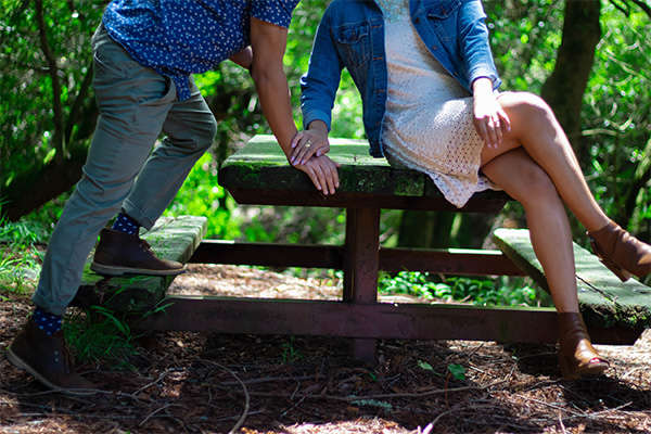man and woman sitting at table outside