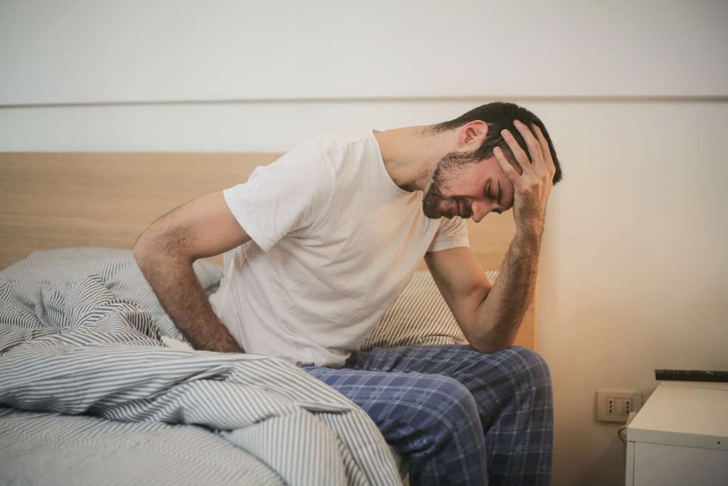 man sick in bed after the season changes
