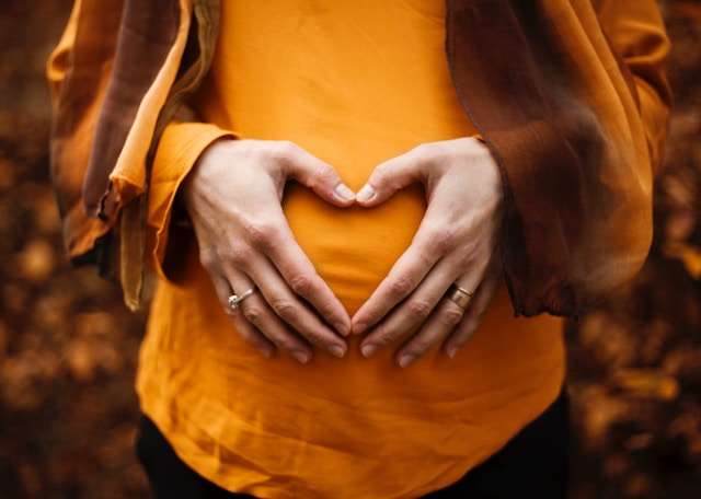 pregnant woman holding belly