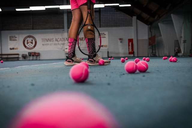 Student playing tennis with pink tennis balls