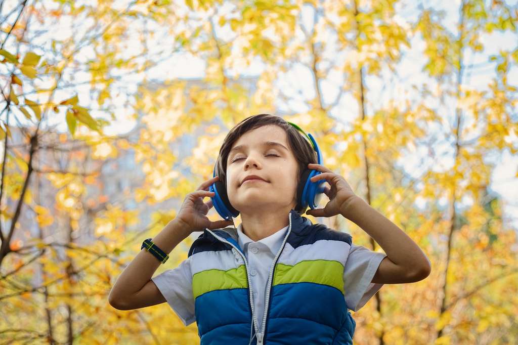 young child with headphones on